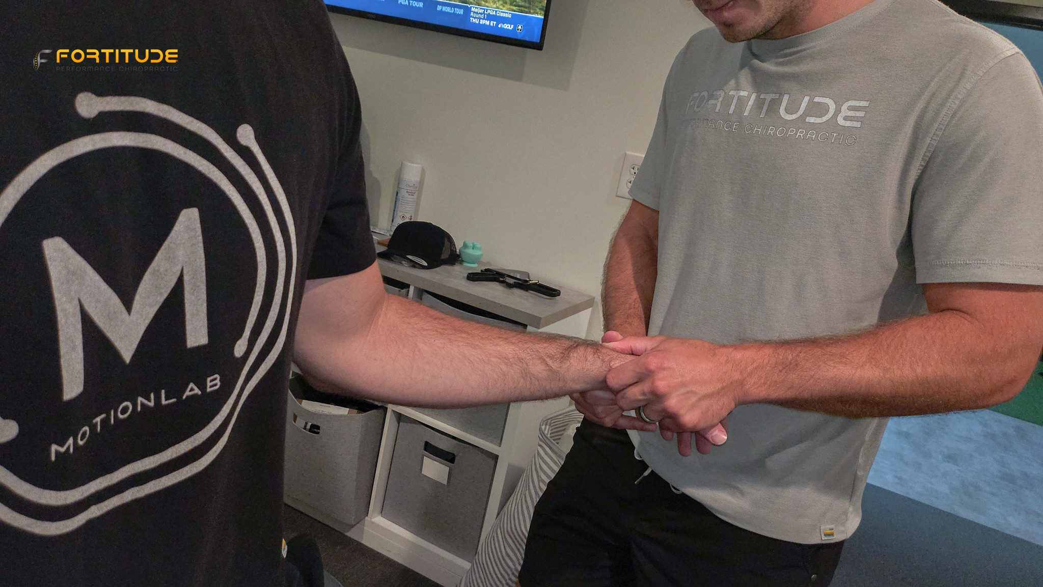 close-up of wrist joint assessment by sports chiropractor at Fortitude Performance Chiropractic, in clinical setting