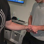 close up of wrist assessment by sports chiropractor Fortitude Performance Chiropractic in a clinical setting