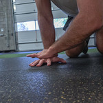 forearm stretch on gym floor for wrist mobility