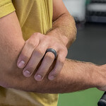 Golfer gripping elbow in pain during swing, demonstrating symptoms of golfer’s elbow or forearm strai