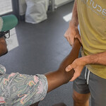 Golf athlete receiving functional elbow assessment from sports chiropractor at Fortitude Performance