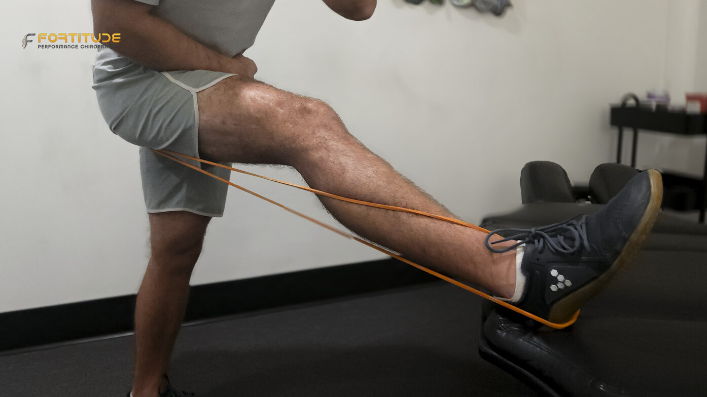 Demonstration of sciatic nerve tension using resistance bands to simulate nerve path and mobility limitations.