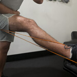 Demonstration of sciatic nerve tension using resistance bands to simulate nerve path and mobility limitations.