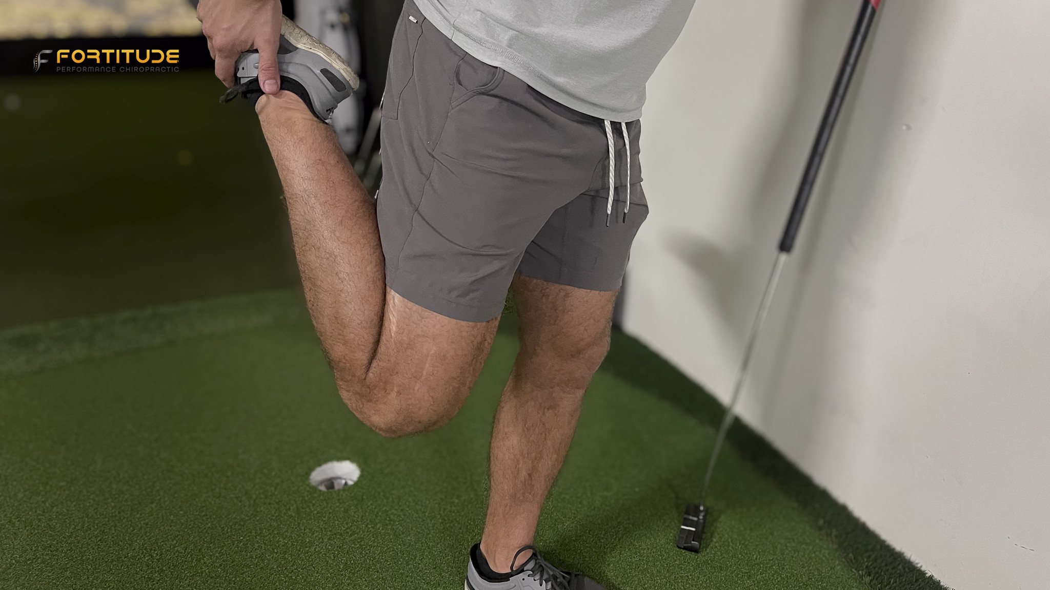 person doing a quad stretch as part of a warm-up, illustrating a common static stretching exercise.
